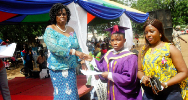  Ms Cecilia Obenewa Appiah (left) the Headmistress of Krobo Girls Senior High School,  presenting a certificate to Gifty Maku Tetteh, one of the graduands. Picture: Ezekiel Sottie